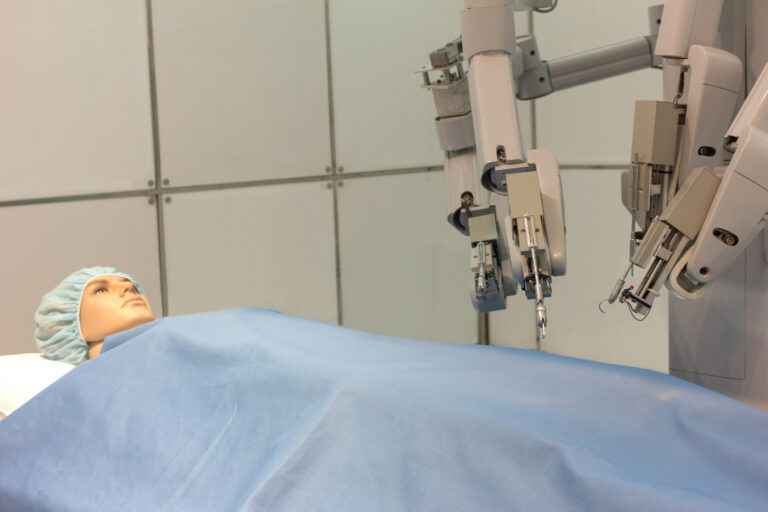 a surgical robot undertaking a test on a plastic doll patient