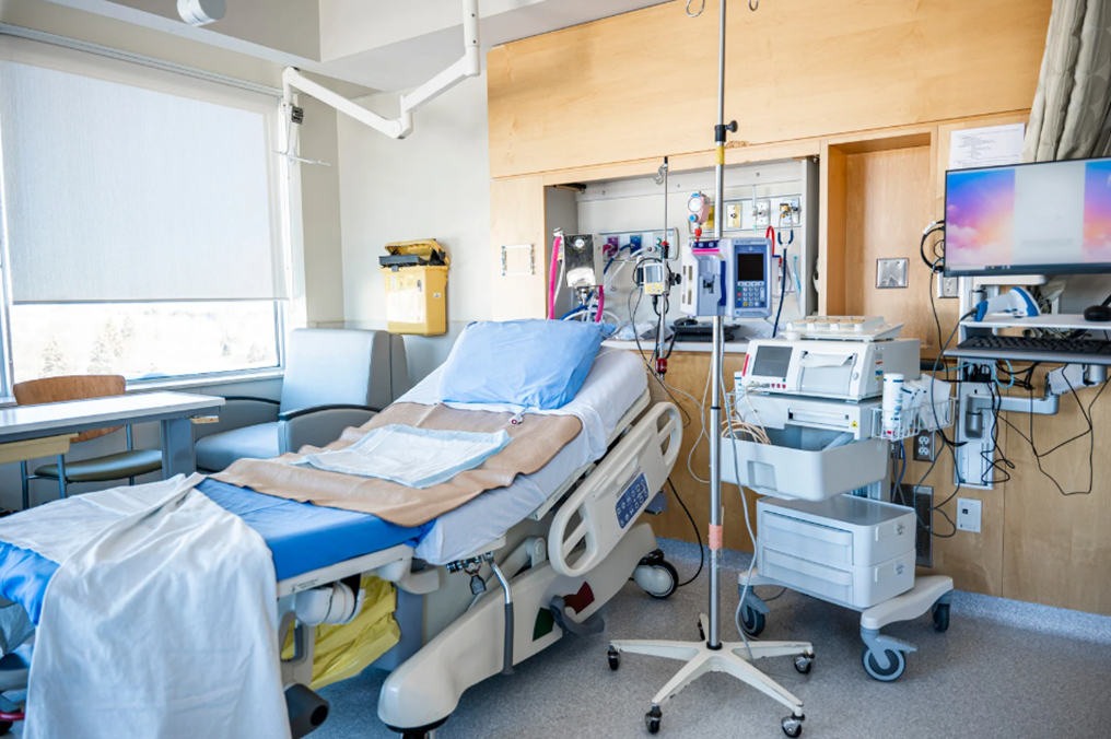 A hospital room with a bed and medical equipment